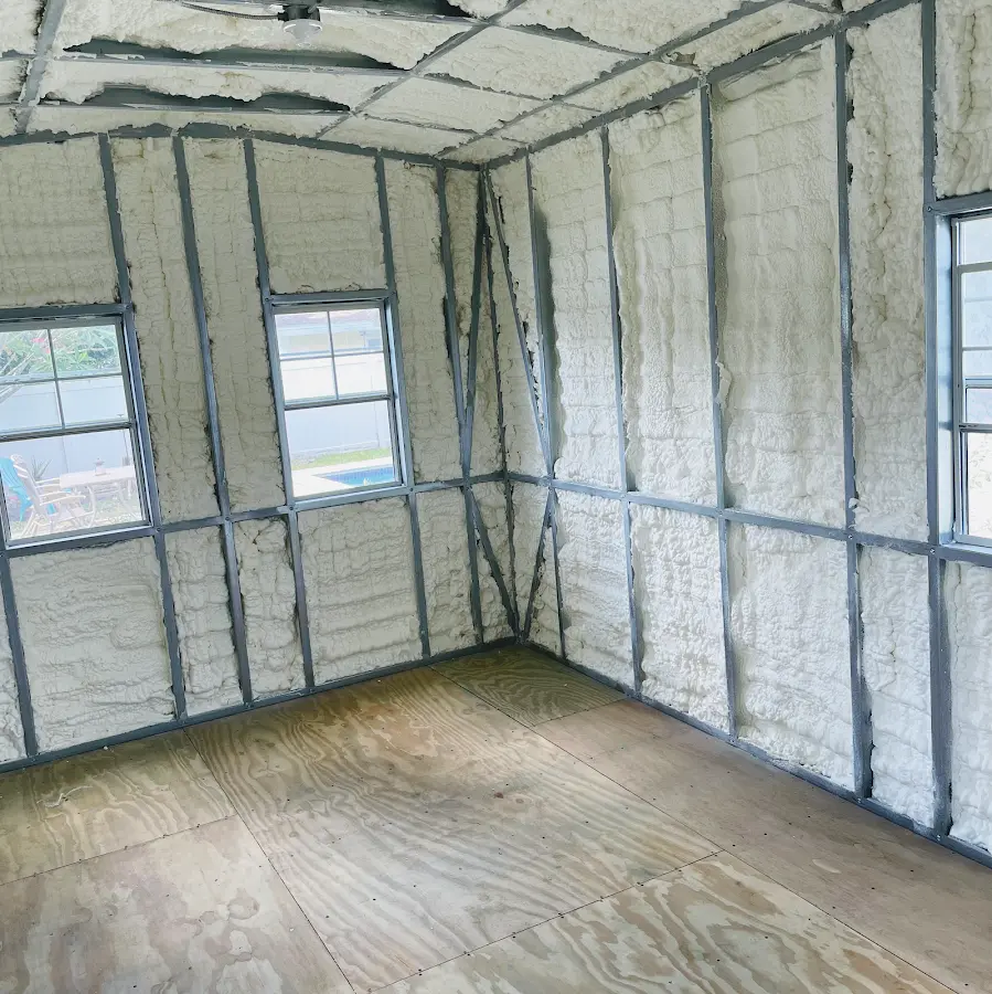 Closed-cell spray foam insulation applied to wall cavities in a residential project in Brookhaven